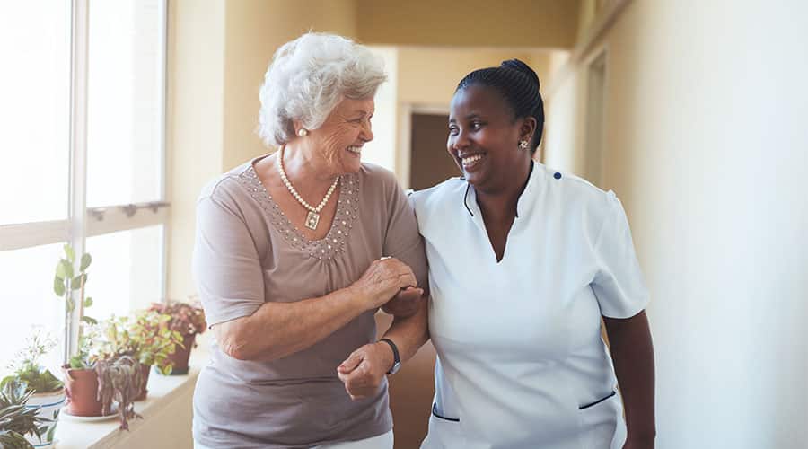 In-Home Alzheimer'S Caregiver Provides Transportation And Accompanies A Senior Woman To Her Doctor Appointment. 