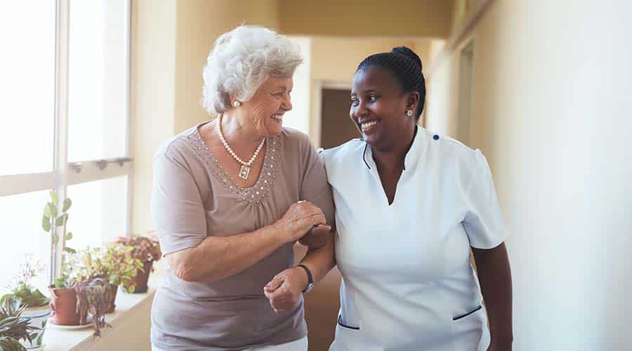 A home health aide helps a senior with dementia to go to doctor's appointments, hourly help for seniors A home health aide helps a senior with dementia to go to doctor's appointments, hourly help for seniors